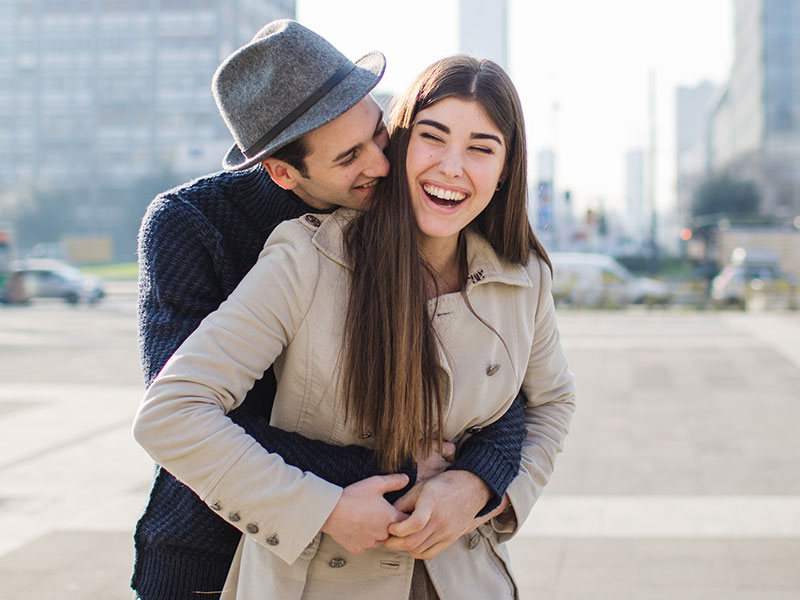 A couple flirting in the city.