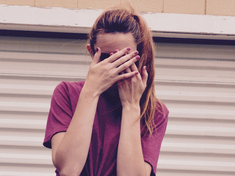 A woman pretending to be shy to tease a guy.