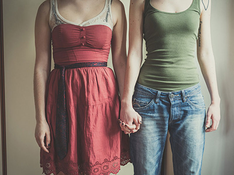 Two women holding hands.