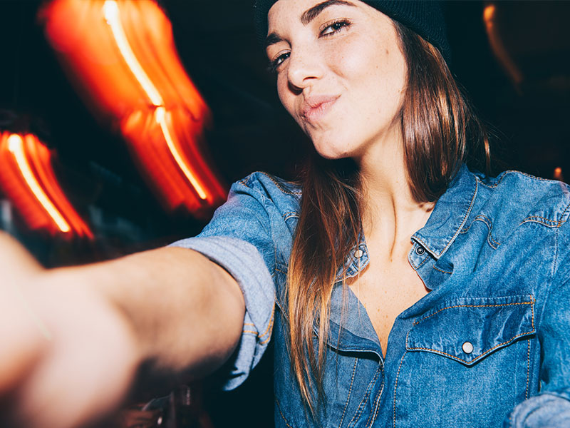 A girl talking a selfie of herself for her online dating profile.