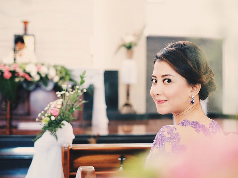 A bridesmaid at a wedding wishing she could be the bride.
