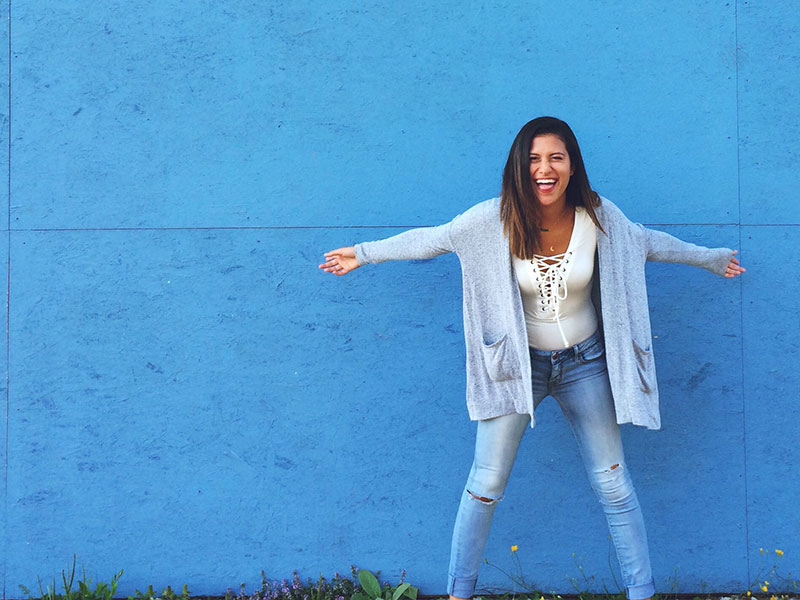 A newly single woman throwing her arms out in happiness.