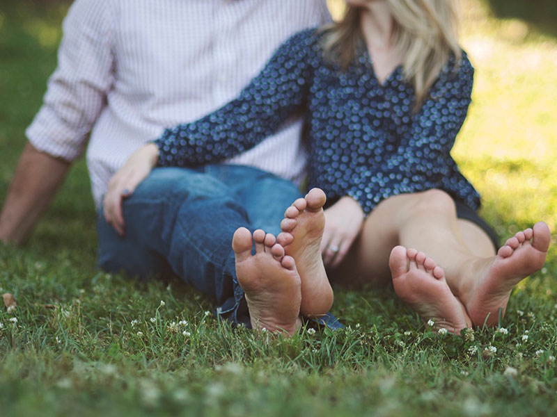 A couple in love sitting in the spring time grass.