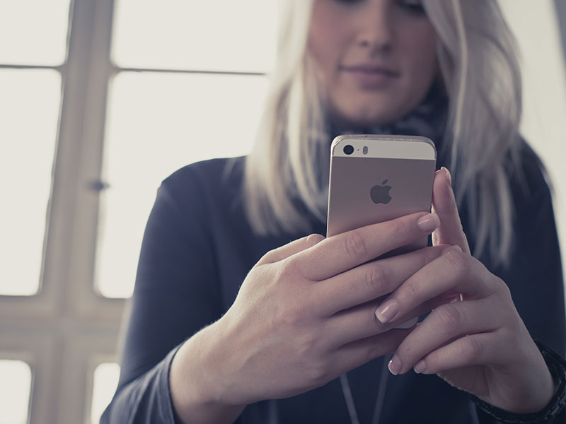 A woman texting on her phone.