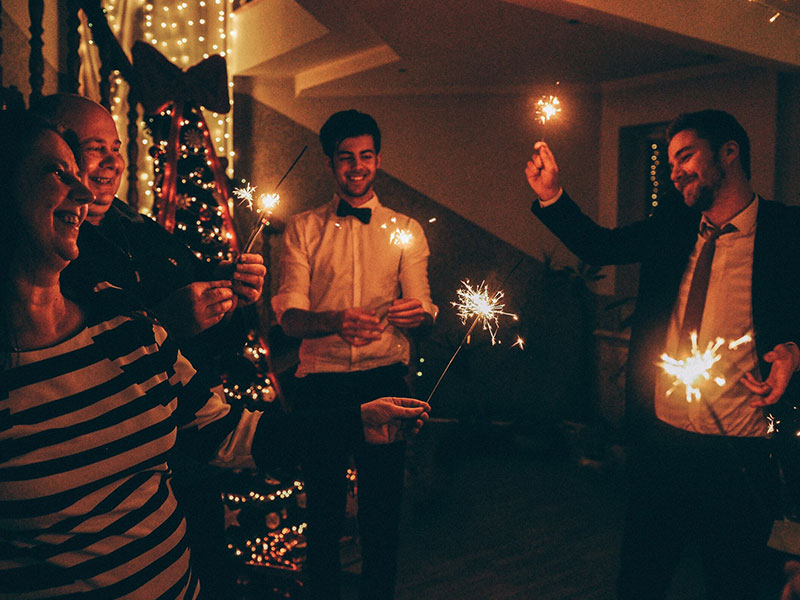 A woman who's single during the holidays having a great time at a holiday party.