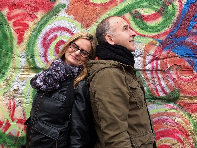 A couple dating at 50, leaning against each other and smiling.