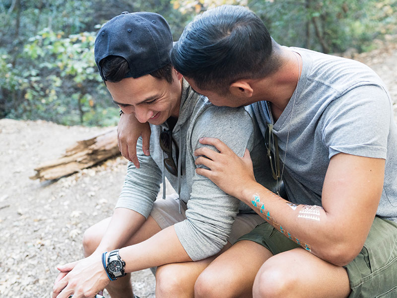 A couple hugging on a rock after finding ways to spend more time together.