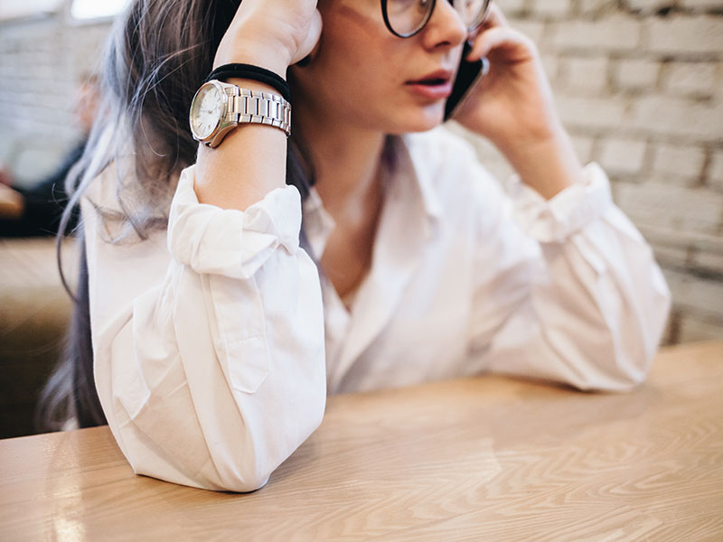 A woman who's trying to learn how to overcome jealousy in a relationship on the phone arguing with her boyfriend.