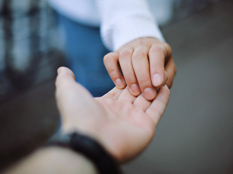 A couple going through a trial separation letting go of each other's hands.