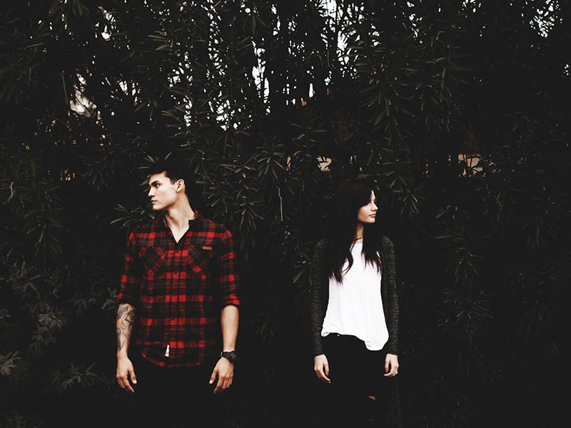 A girl who feels like my ex hates me, standing next to her ex and looking away as they both look mad.