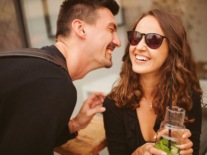 A couple of friends who have a crush on each other flirting and laughing and getting close to crossing the line into emotional infidelity.