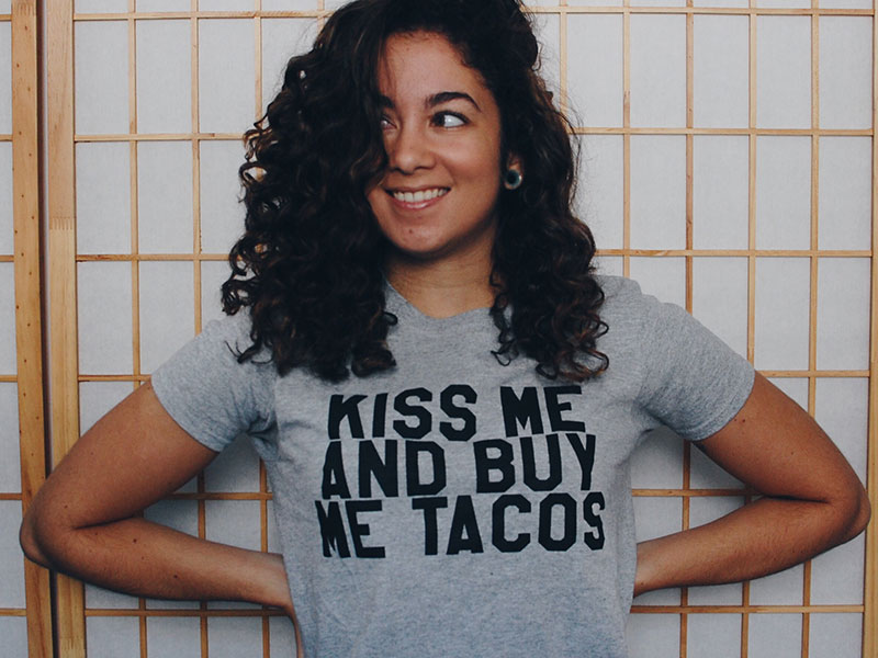 A girl smiling and waiting for a guy to figure out "should I ask her out?"