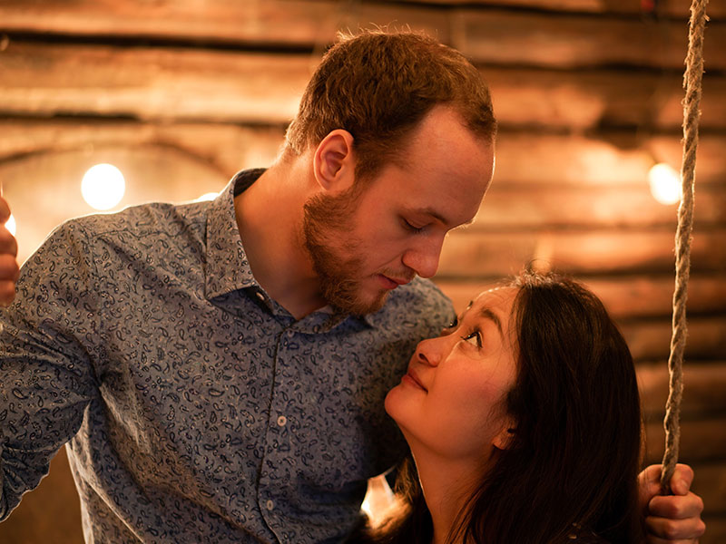 A woman who's wondering what is casual dating, looking up at her date longingly.