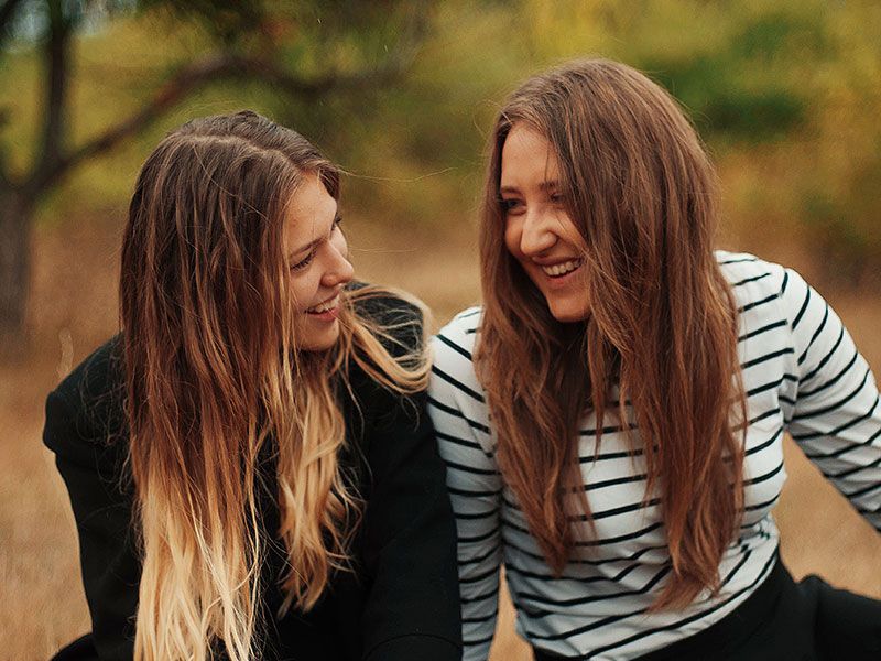 A couple in a new relationship talking outside and laughing.