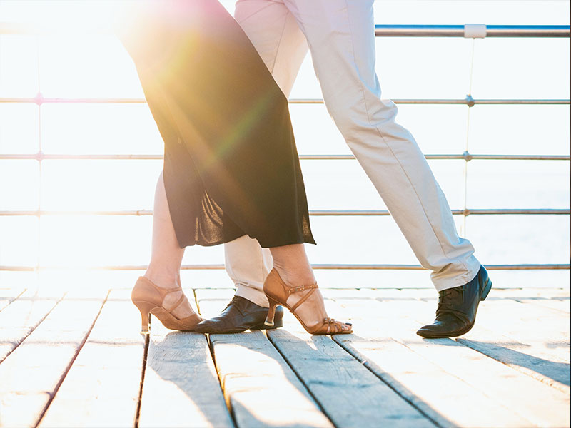 A man who was looking where to meet women, dancing with a woman at a dancing class.