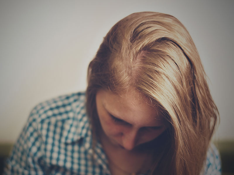 A woman in a codependent relationship thinking about how she can change her mindset.