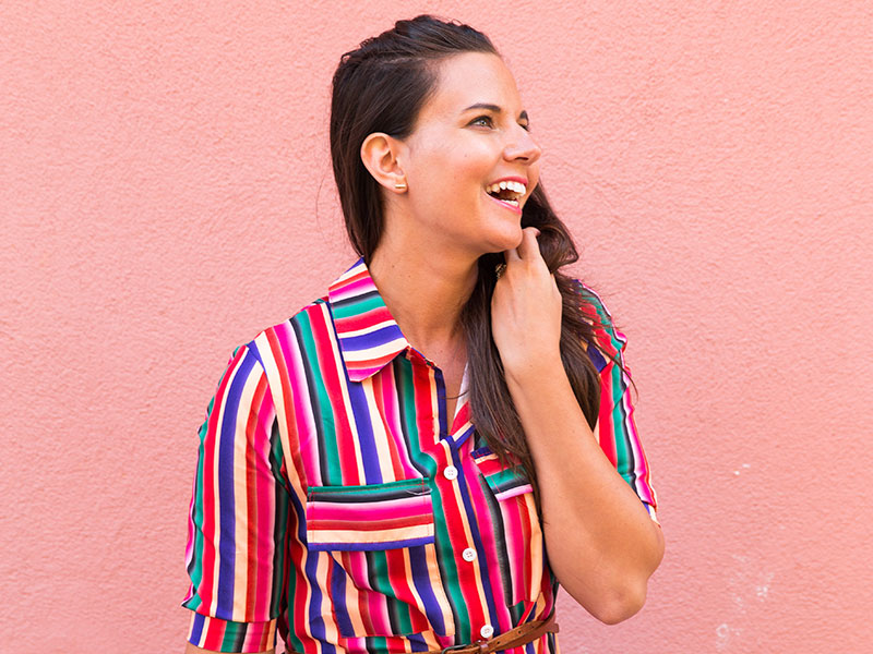 A woman laughing and being happy, showing one of the qualities of a good woman.