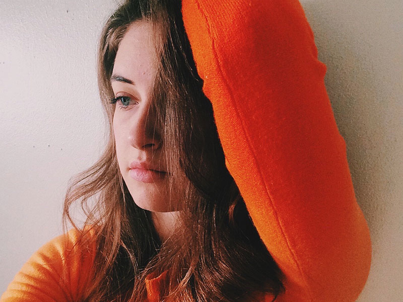 A girl going through a friendship breakup looking sad and upset.