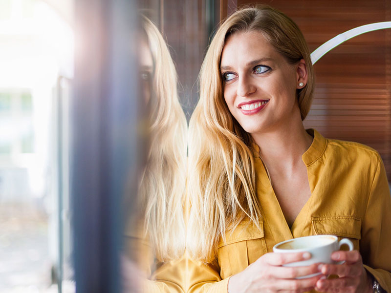 A woman at a coffee shop, a good place to meet single women.