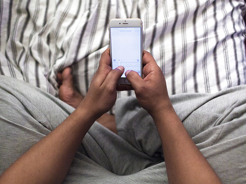 A man sending a missing you text.