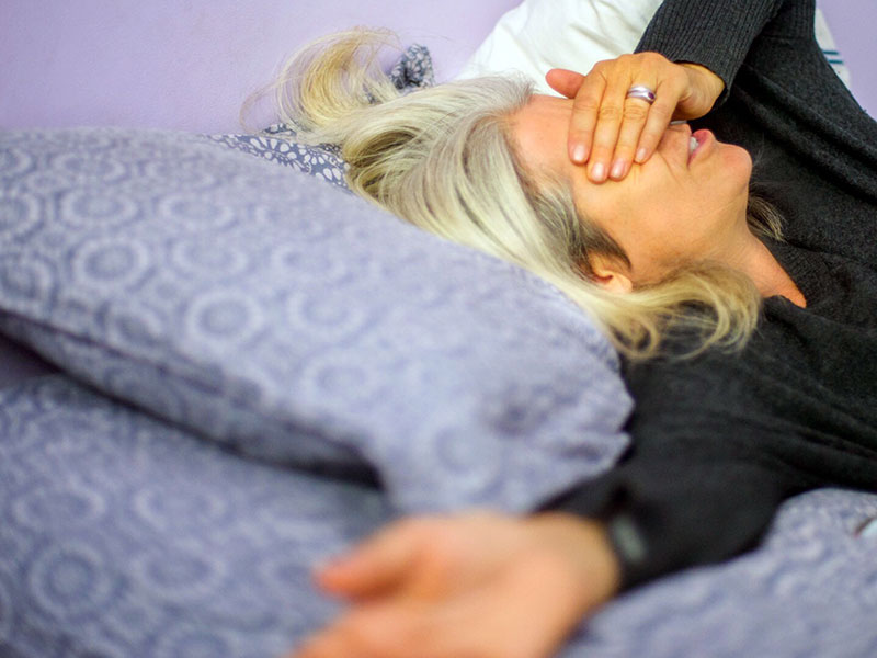 A woman who's divorcing a narcissist looking stressed out and upset.