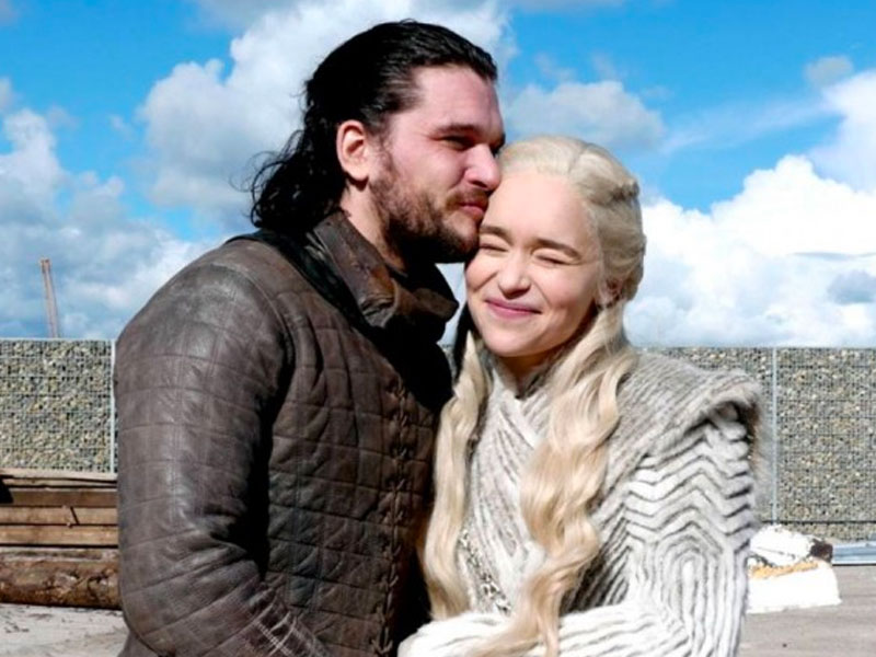 Jon Snow and Daenerys laughing and canoodling on the set of Game of Thrones.