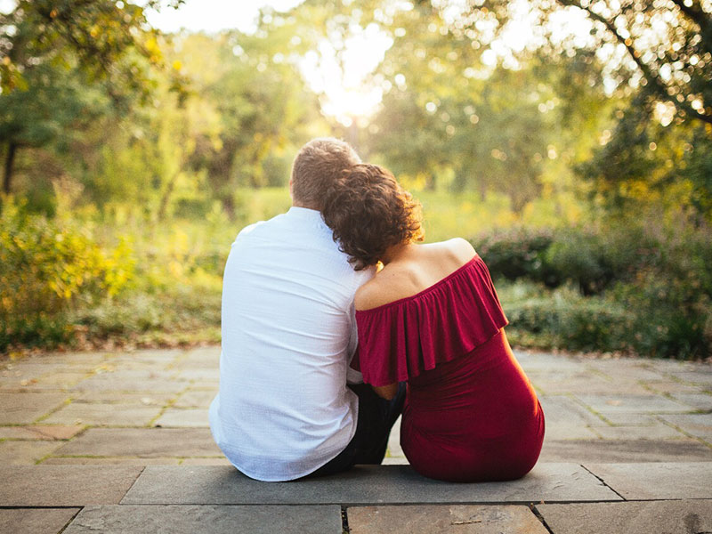 A couple leaning against each other and wondering, "Is love real?"