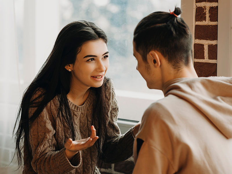 A girl saying a few of these things cheaters say to her boyfriend while arguing in a cafe.