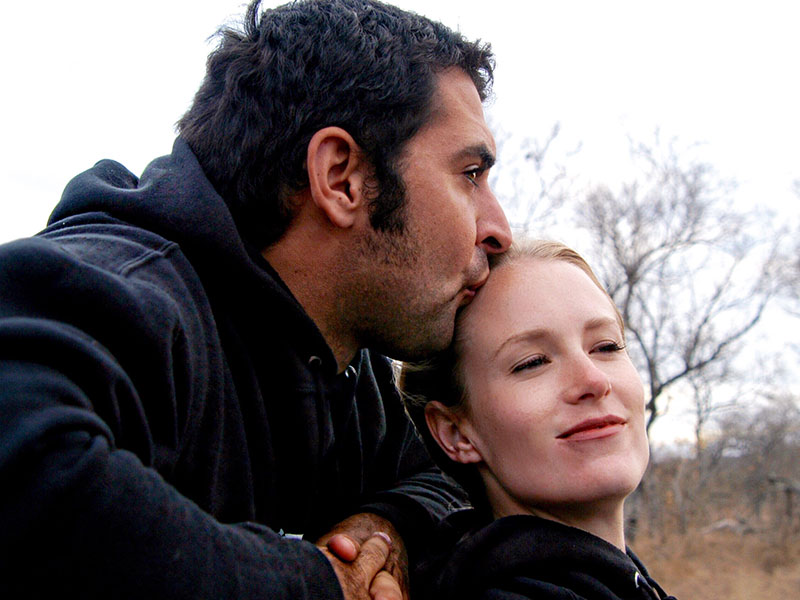 A divorcee dating and kissing his date on the forehead on a hike.