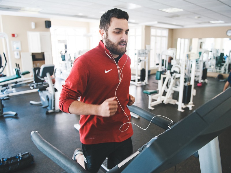 Man runs on treadmill to get in shape, because he's tired of being single.