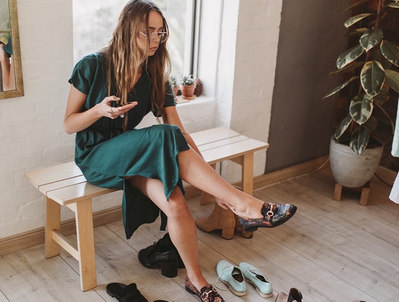 Woman trying on shoes for her first date outfit