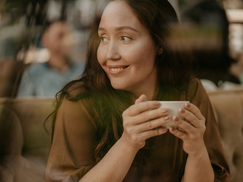 an attractive woman who is 40 and single in cafe with coffee
