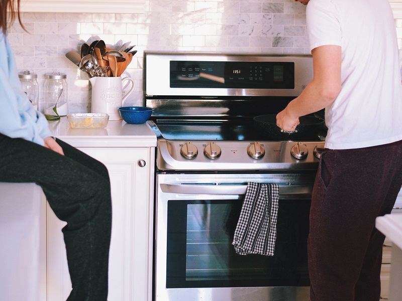 couple cooking in kitchen having a date night at home