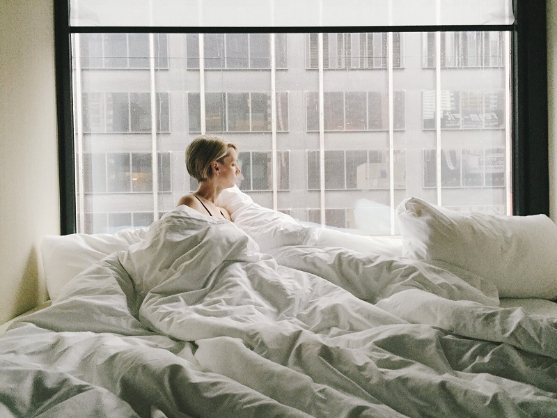 a woman lying in bed wondering what to do when your husband doesn't want you sexually