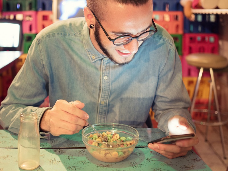 man sitting at kitchen table learning how to write a dating profile for a man