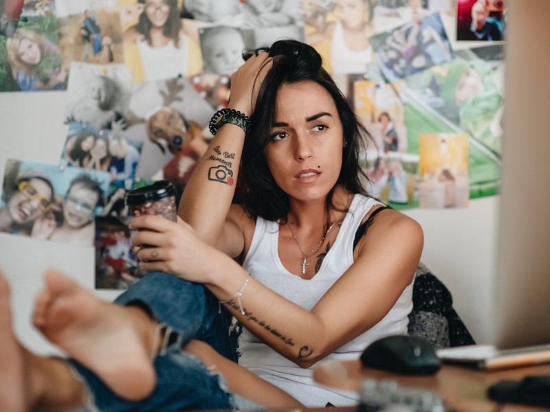 An attractive woman sitting at her desk thinking about her enmeshed relationship