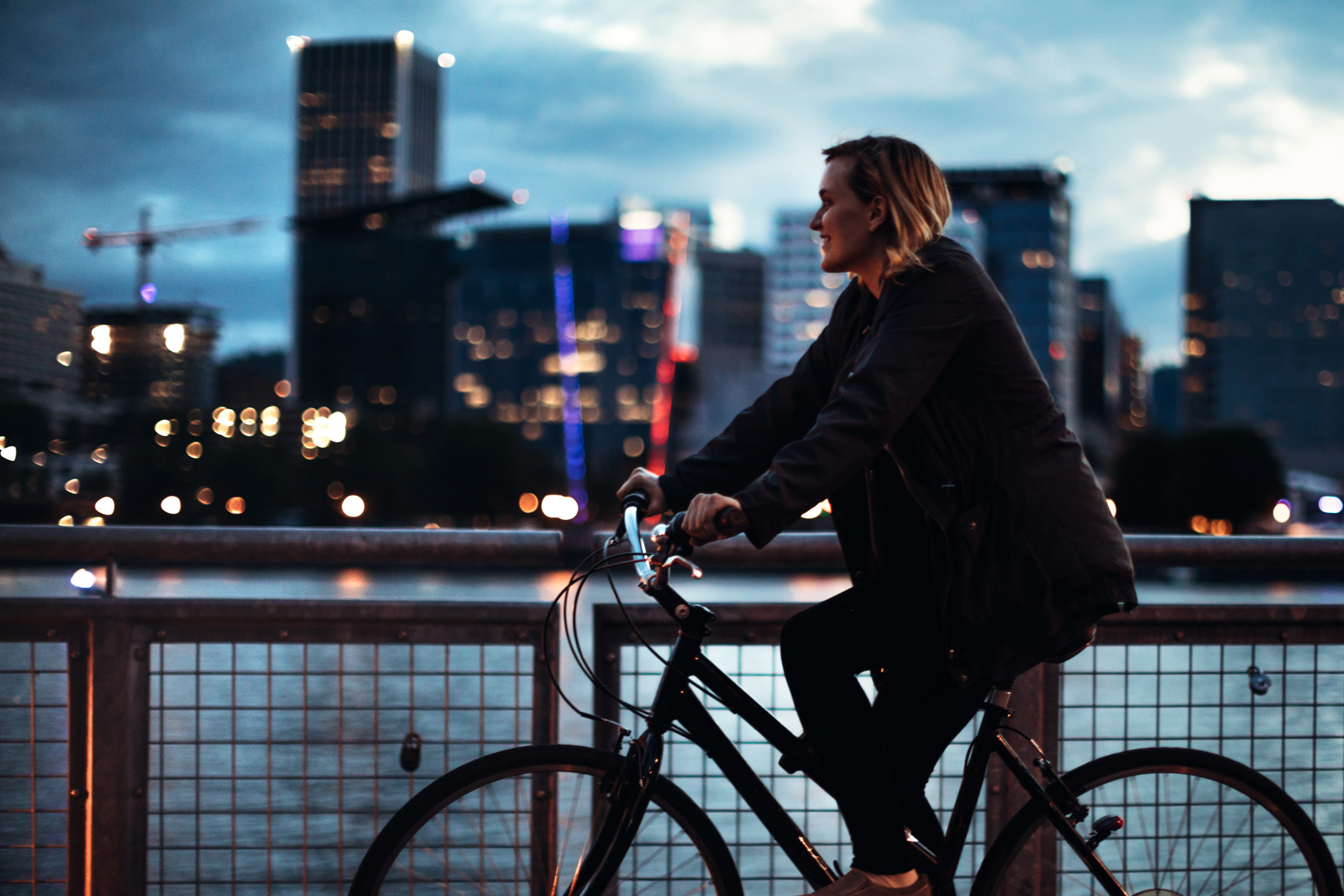 woman cycling on bike across bridge in Portland