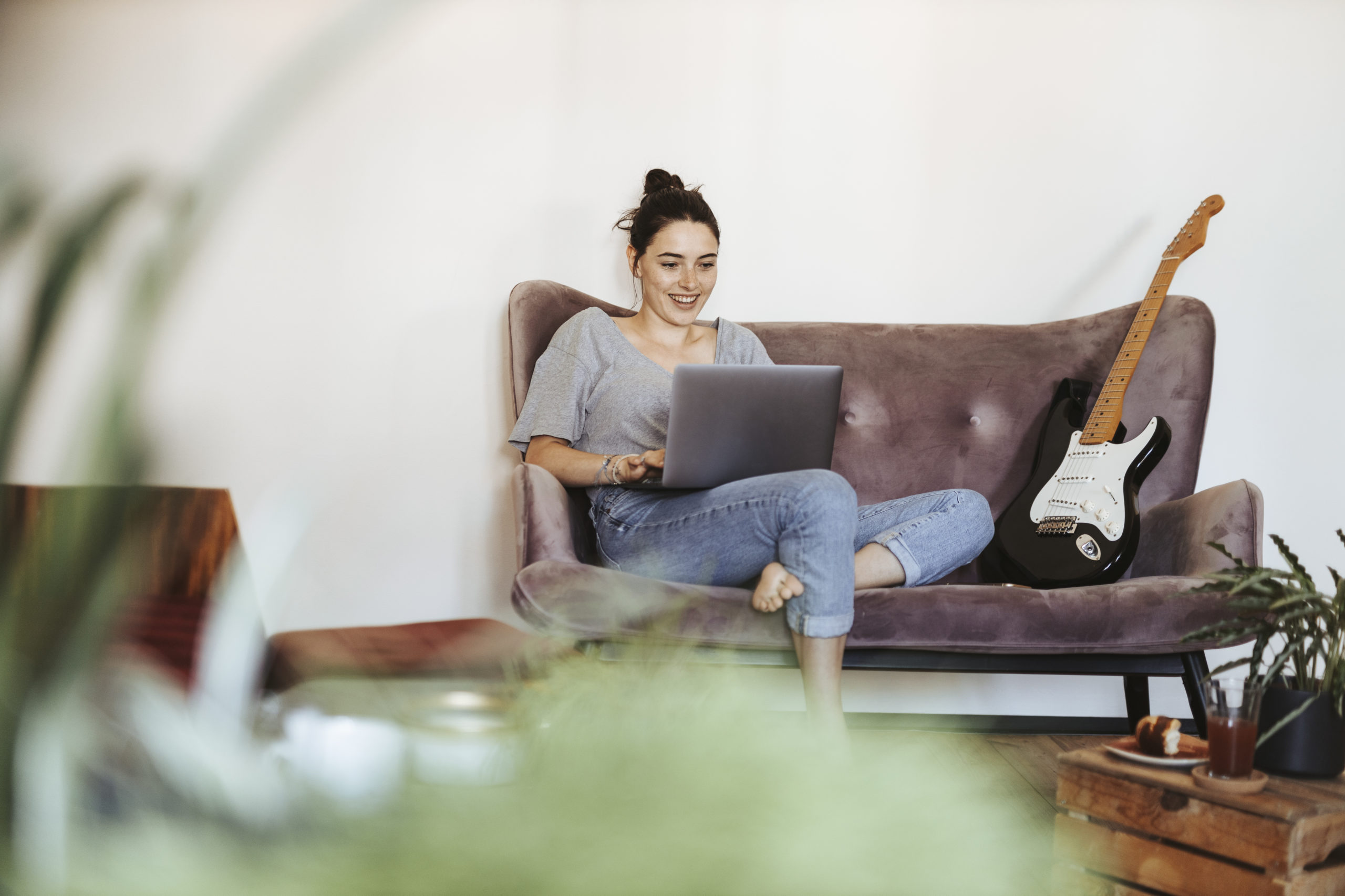 Woman smiling and using laptop to meet people online.