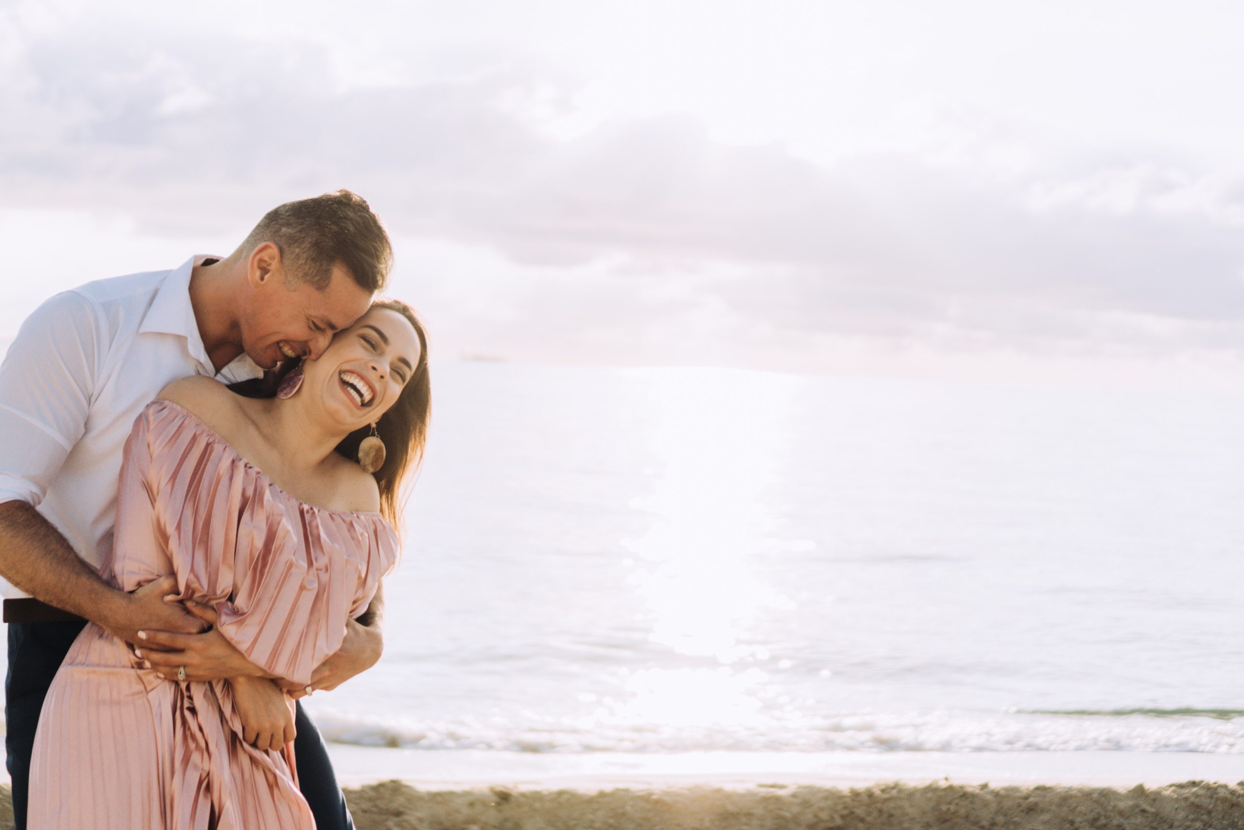 Happy couple smiling, laughing, and embracing each other while dating in Jacksonville FL.