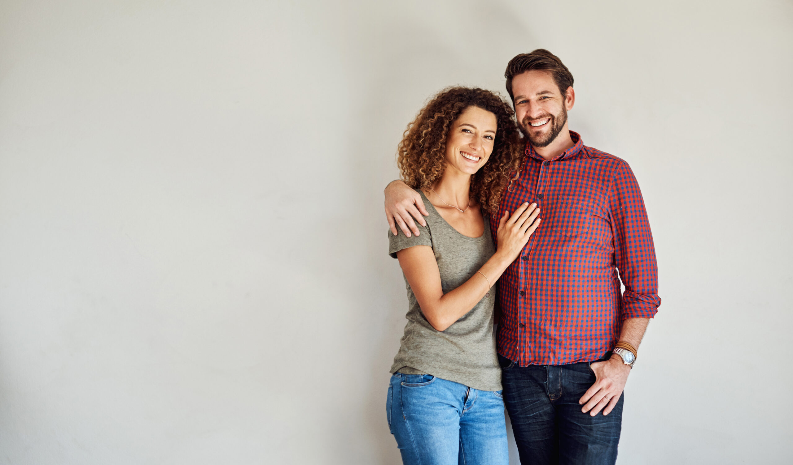 Portrait of two Christian singles happily smiling and embracing each other while dating.