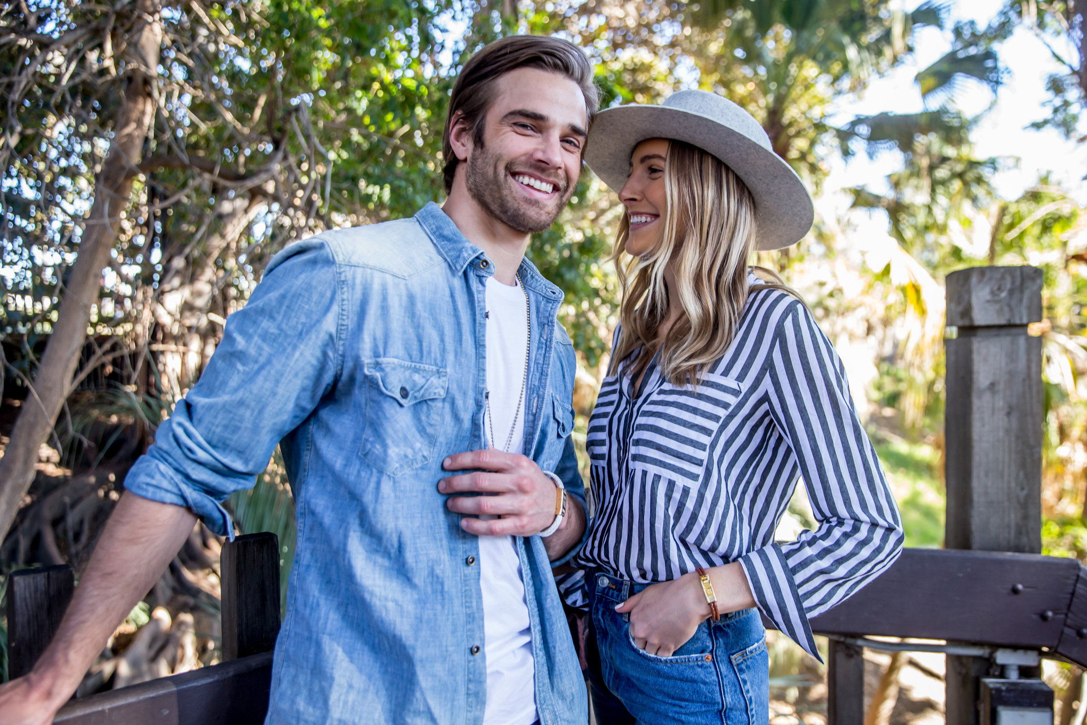 Happy, smiling couple standing outdoors in the sunshine while dating in Sacramento.