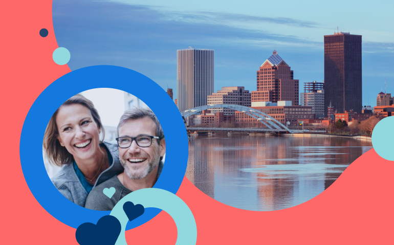 Happy, smiling couple embracing each other while dating in Rochester NY.