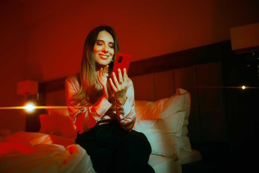 A woman on the couch looking at her phone.